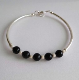 Black pearls make a striking contrast in this handmade Sterling silver bangle
